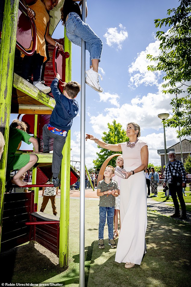 As a little girl slid down a pole in the playground, Queen Máxima looked worried.