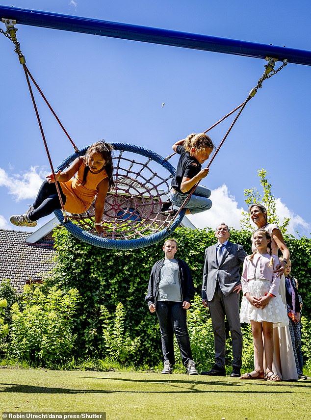 Smiling as the little girls on the swing picked up pace, the royals looked radiant as ever.