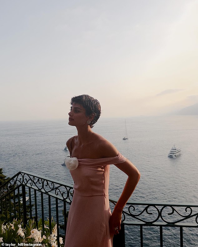 This pale pink off-the-shoulder dress had a beige flower in the center.