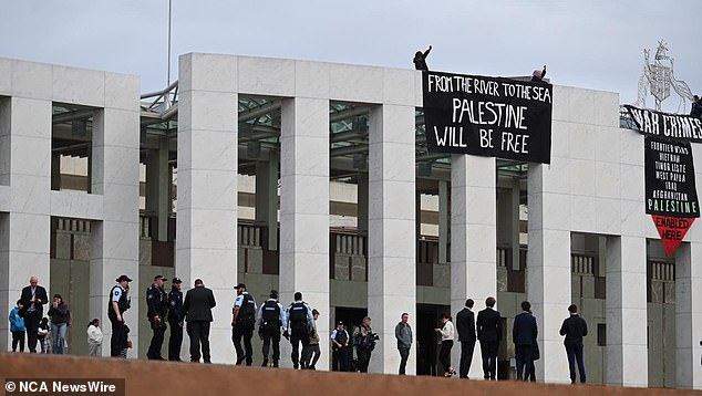 Pro-Palestinian protesters scaled the roof of Parliament in a show of support for Palestine. Photo: NewsWire/ Martin Ollman