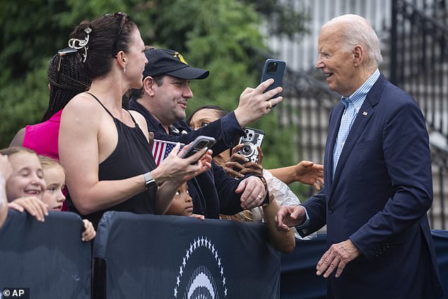 President Joe Biden poses for photographs after delivering brief remarks to military members and their families on July 4