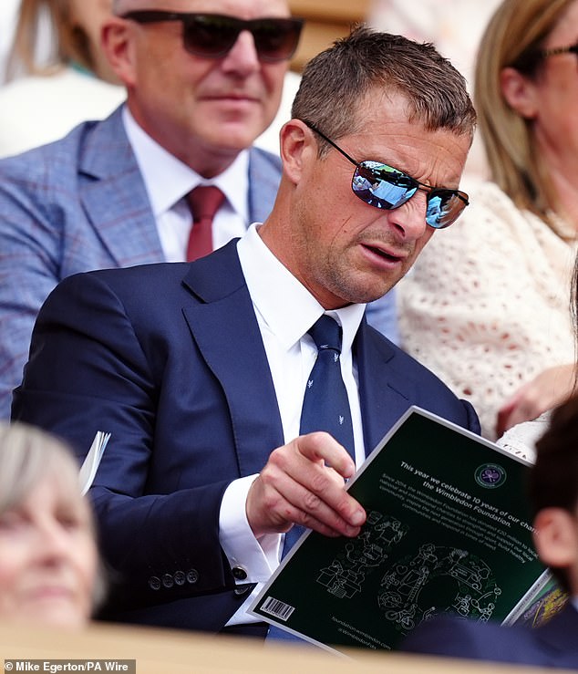 Bear put on a pair of sporty sunglasses as he read the programme for the fourth day of the sporting event.