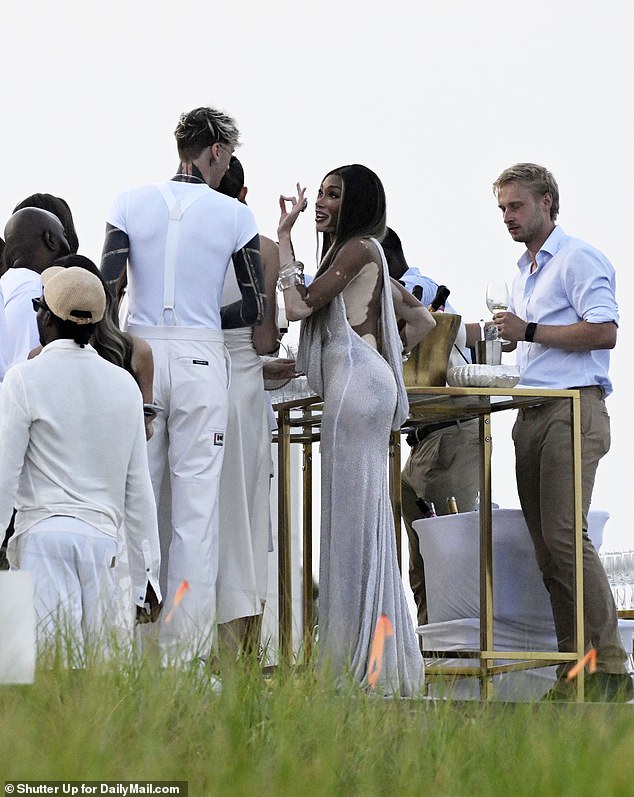 Also in attendance was Machine Gun Kelly, seen here chatting with Harlow as the party got underway.