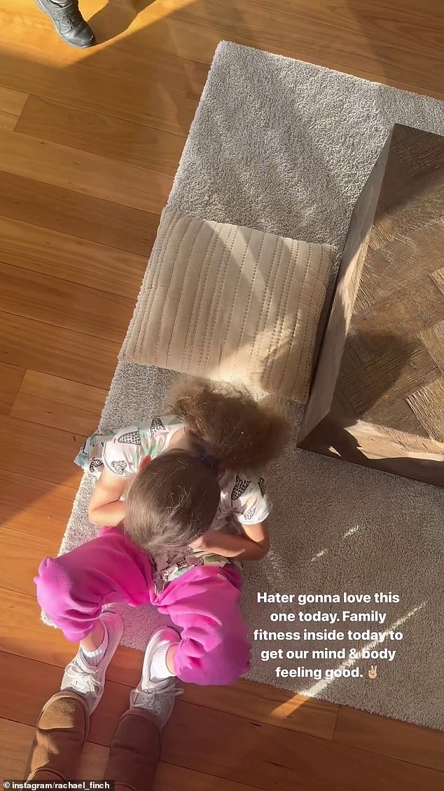 In the video, Rachael, who shares daughter Violet, eight, and son Dominic, five, with husband Michael Miziner, can be seen stepping on her daughter's feet as the eight-year-old does sit-ups.