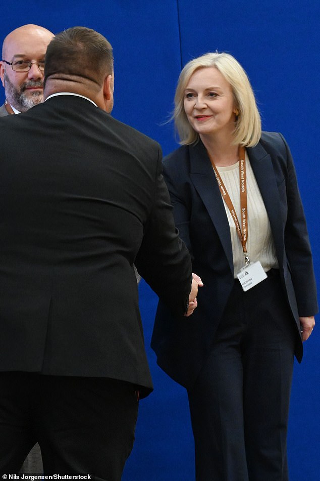 Terry Jermy shakes hands with Ms Truss after her victory in the King's Lynn by-election recount for south west Norfolk