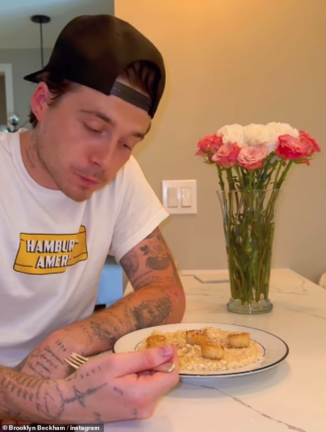 A casual figure with his baseball cap on backwards, he then sat down to enjoy his meal and gave the camera a thumbs up.