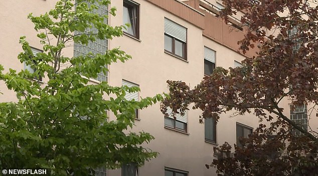 The newborn fell from a 12-foot-high apartment window onto the runway (pictured is a general view of the apartment building)