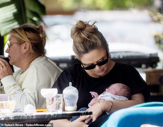 Emily looked effortlessly chic on the outing in a long black dress and sunglasses.