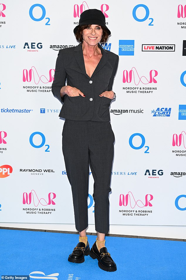 Walking the blue carpet, Lisa Stansfield showed off her quirky sense of style in a dark grey suit.