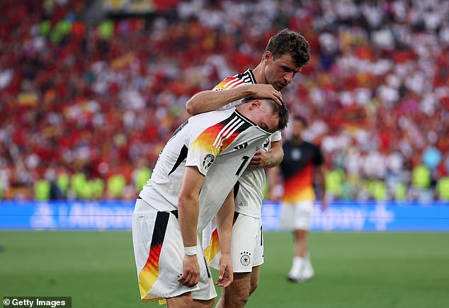 Thomas Müller consoled Florian Wirtz at the end of the match as Germany's tournament came to a close