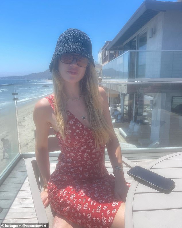 Sean also posted photos of his new girlfriend on Instagram. She was wearing a red dress and a bucket hat with sunglasses as she sat on a balcony of a seaside restaurant in Malibu.