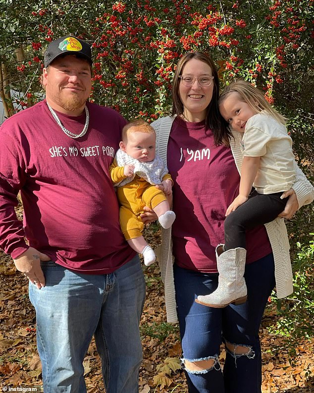 The couple appears in the photo with their two oldest children.