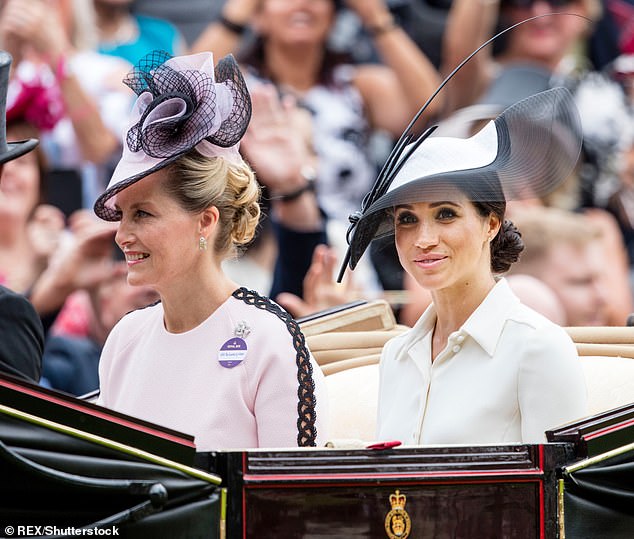 Sophie is pictured sitting next to Meghan in a carriage for Royal Ascot in 2018