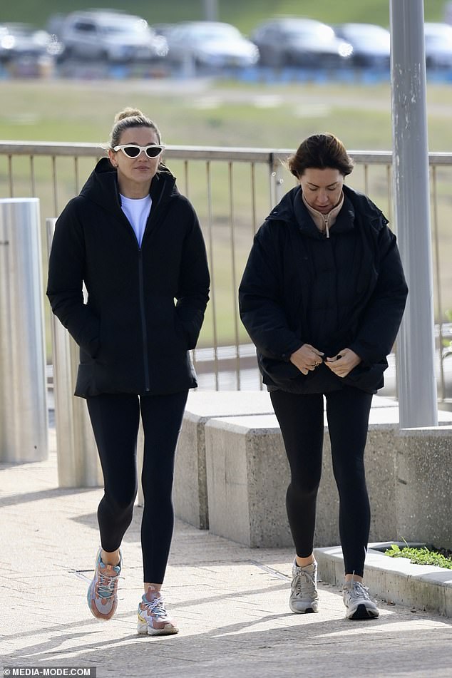 The designer stepped out for a stroll on Bondi Beach with her good friend and former business partner, chicken heiress Tamie Ingham (left)