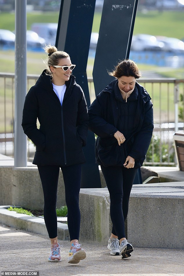 She wore a white T-shirt underneath, and added a pair of black tights and colorful sneakers.