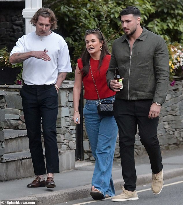 He teamed the smart-casual ensemble with a pair of beige boat shoes and was photographed leaving the boat trip with a bottle of cider in hand.