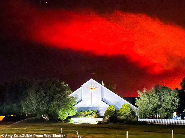 In Santa Ynez, a church stands against the ominous backdrop of the lake fire.