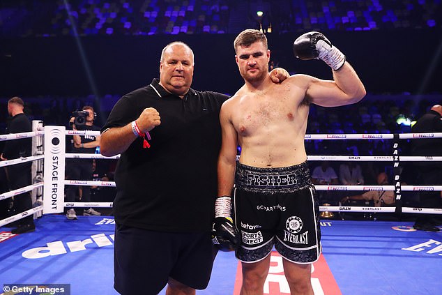 Fisher poses for a photo with his father, John, after the win at the Copper Box Arena