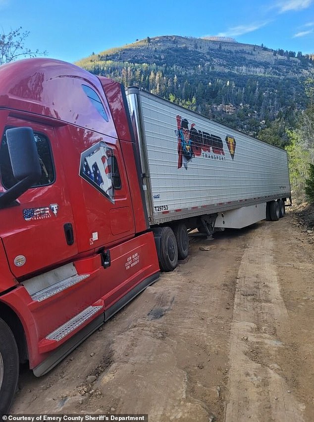 An 18-wheel semi-trailer truck hauling a 53-foot refrigerated trailer full of Red Bull (pictured) became stuck in mud after its navigation system led the driver off-road.