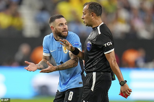 Nahitan Nandez argues with referee Dario Herrera after being shown a red card