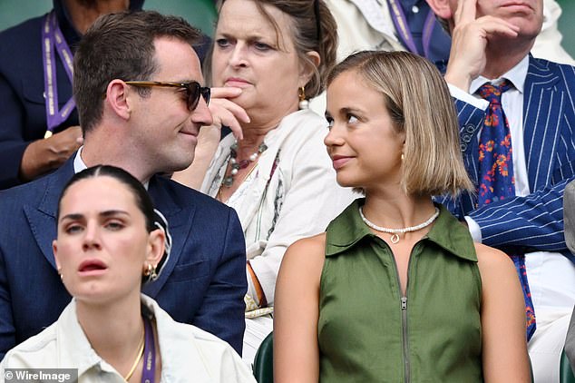 Amelia beamed from centre court as she cuddled up to her boyfriend Ollie during one of the matches.