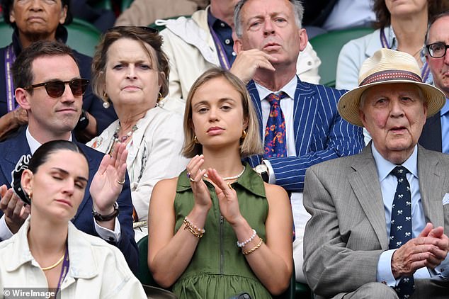 Ollie looked dapper in a navy suit, while he also matched Amelia's dress by adding a green tie.