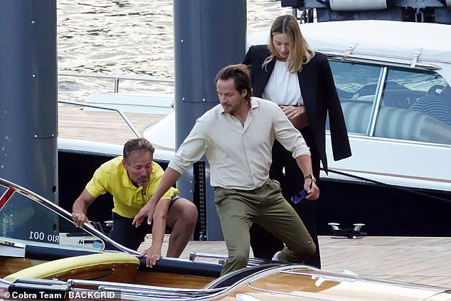 Tom was in action helping her down into the boat.