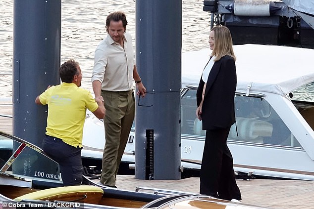 Tom waved to the boat driver as they pulled into the dock.