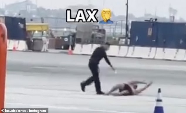 The footage shows the man running as an LAPD officer chases him closely. He appears to point his taser at the man, who eventually falls to the ground.