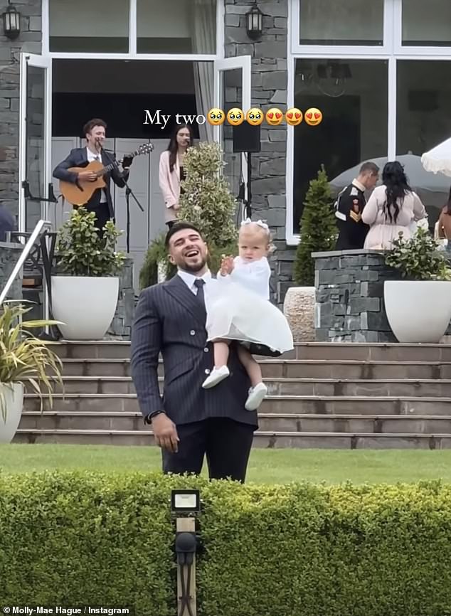 The 25-year-old influencer wore a stunning one-shoulder dark blue gown as she walked down the aisle with her daughter and flower girl, Bambi, 17 months (Tommy Fury and Bambi pictured).