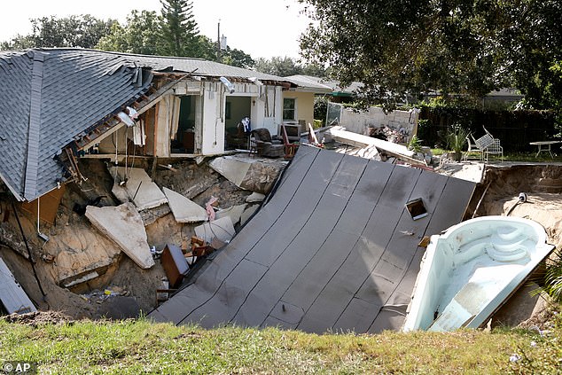 A home is destroyed after the backyard behind the house collapsed into a sinkhole, taking its patio and boat with it in November 2013 in Dunedin, Florida.