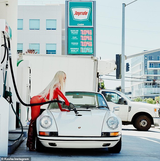 Kesha posed in a tight red outfit while pumping gas into a white sports car in a promotional photo for her new song Joyride.