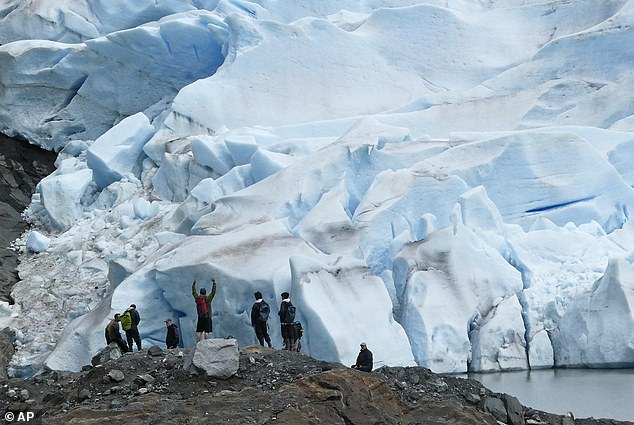 A group of people take in the view of Mendenhall Glacier on June 8, 2023, near Juneau.