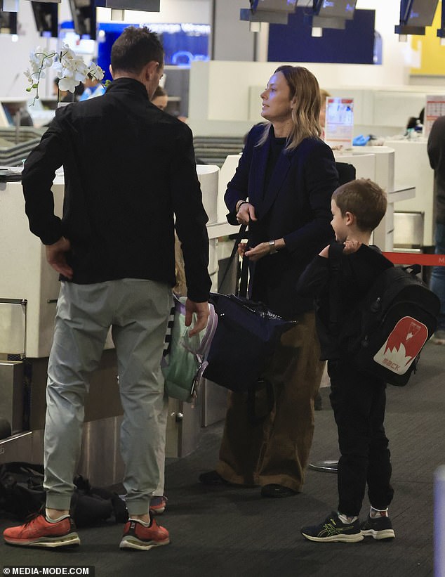 The A Current Affair presenter, 45, was spotted checking in for an international flight at Sydney Airport with her husband Michael and sons Mack, seven, and Scout, four.