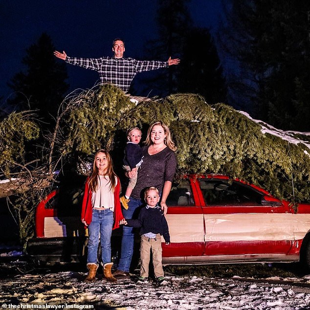 Jeremy Morris is pictured with his wife Kristy and their Christmas decorations at their home in Hayden, Idaho. He has been embroiled in a court battle with his homeowners association over the decorations.