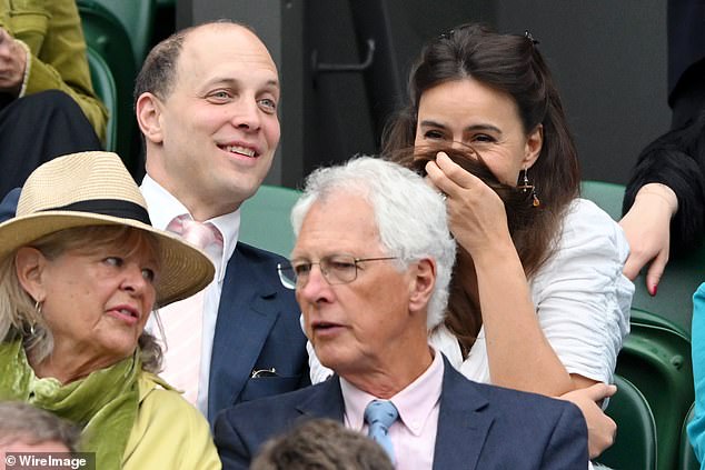 As they sat down for the tennis match, Sophie appeared to be hiding her face in her hair as they shared a giggle while watching.