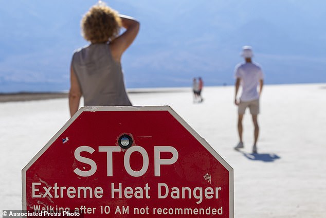 A person wipes sweat from his brow at Badwater Basin in Death Valley National Park, where someone died Saturday.