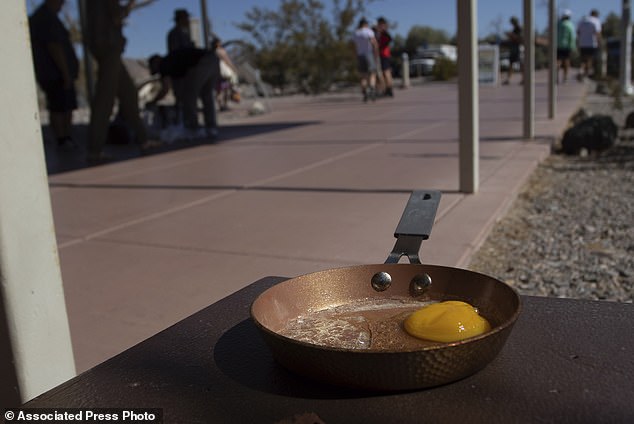 An egg sits in a small pan at the Furnace Creek Visitor Center in Death Valley National Park, Calif., Sunday, July 7, 2024. Forecasters say a heat wave could break previous records across the United States, including in Death Valley. (AP Photo/Ty ONeil)