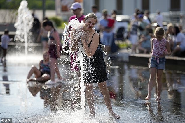 June marks the 13th consecutive month of record-breaking temperatures globally. Pictured, a woman cools off in a fountain in Moscow, Russia, June 30, 2024.