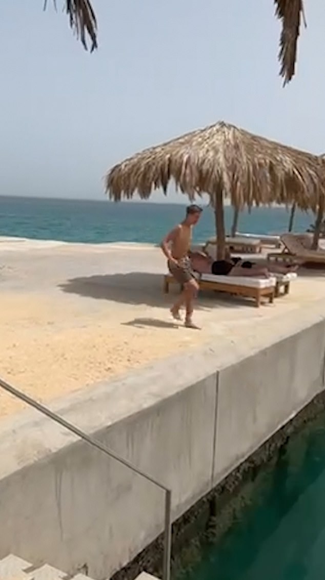 A video from his holiday in Egypt in September shows him laughing and doing the same move from the side of a jetty.