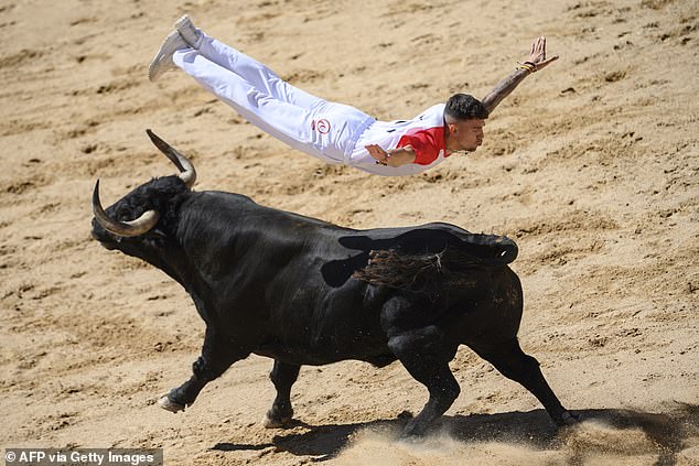 TO "trimmer" (bullfighter) jumps over a bull at the Plaza de Toros during a show after the first day of the San Fermin festival in Pamplona, ​​northern Spain, July 7, 2024