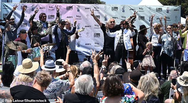 Joe was seen joining Ringo on stage, as he spoke to the gathered crowd and encouraged everyone to put up double peace signs during the traditional exclamation 