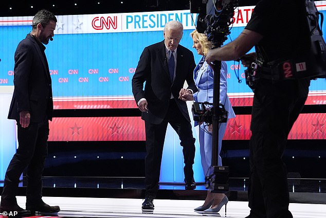 Jill helps her husband Joe Biden off the CNN debate stage after their debate in which Trump was involved in a car crash that sparked calls for him to resign.