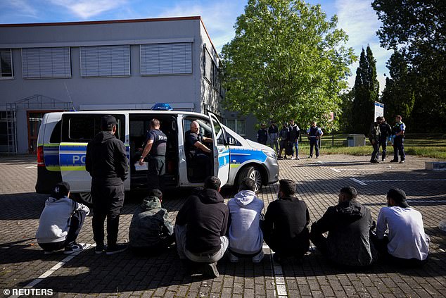 Suspected illegal immigrants sit on the ground after being detained by German police during their patrol along the German-Polish border to prevent illegal migration, in Forst, Germany, September 20, 2023 (file photo)