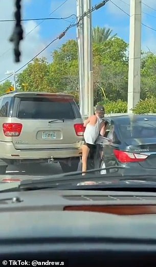 She chases after the vehicle and attempts to get back inside through the front door, but it closes and her leg becomes trapped between the door and a parked van.