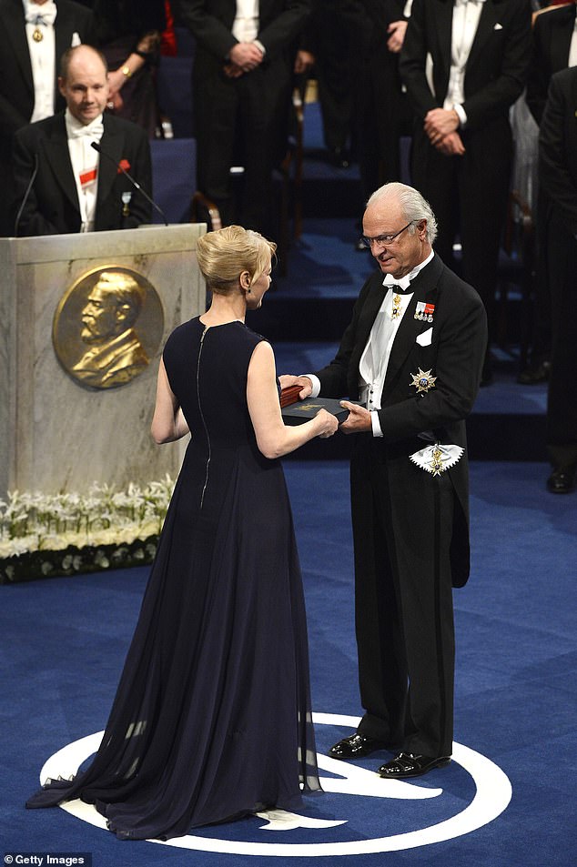 Nobel Prize winner in Literature Alice Munro, represented by her daughter Jenny Munro (left), receives her Nobel Prize from King Carl XVI Gustaf of Sweden in 2013