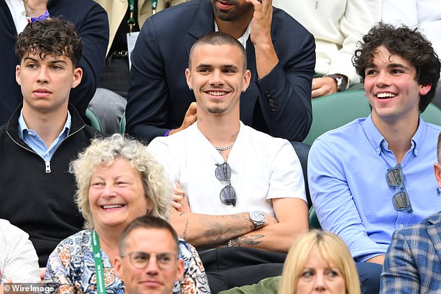 Romeo, 21, stood out in a casual T-shirt alongside his friends who wore smart navy blue shirts.