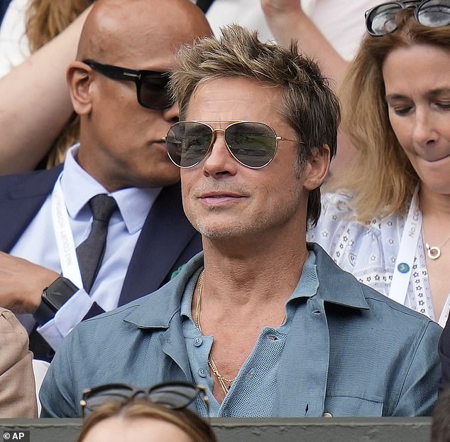 Brad Pitt looked dapper at the 2023 tennis event, opting for a knitted blue polo shirt and matching blazer jacket.