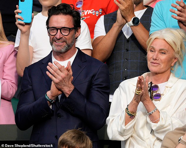 Hugh Jackman (left) applauded Carlos Alcaraz alongside his wife Deborra-Lee Furness (left) while wearing a smart navy blazer.