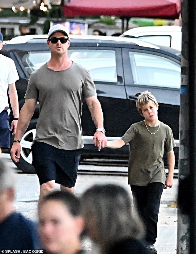 Chris looked effortlessly chic in a grey t-shirt paired with black shorts and Nike sneakers.